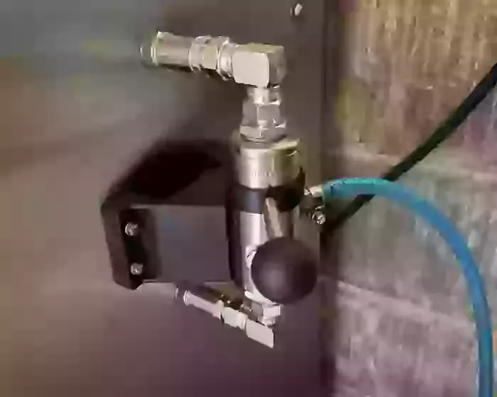 External chemical injector fitted onto the side of a Nilfisk Truck Booster for a farm installation in Ellistown. This modification improved detergent application and cleaning performance for regular agricultural washdown work.